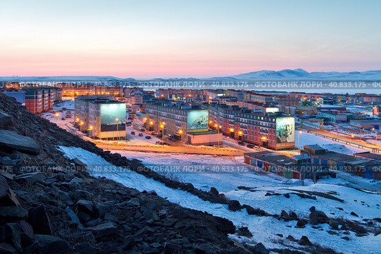 Anadyr, Chukotka, Far North of Russia. Beautiful cityscape. View from the slope of the hill to the town in the Arctic. Multicolored colorful buildings. Snow-covered northern city. Редакционное фото, фотограф Андрей Степанов / Фотобанк Лори