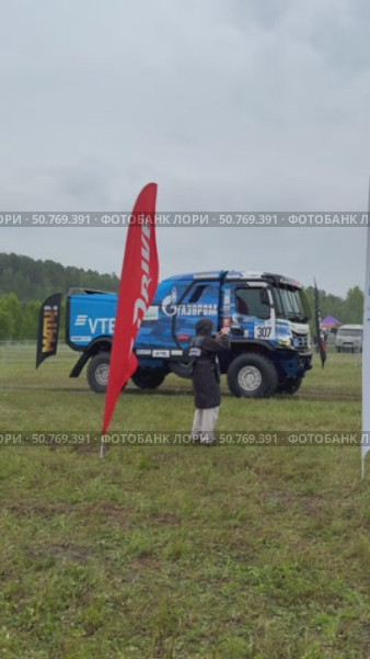 ANGARSK, IRKUTSK REGION, RUSSIA - July 13, 2025: XV International Silk Way Rally, racing competition. Vertical video of famous team of champions of sports truck №307 KAMAZ-master on start in rain. Редакционное видео, видеограф Виктория Катьянова / Фотобанк Лори