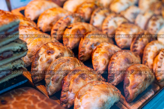 Appetizing savory empanadas showcased on countertop display. Стоковое фото, фотограф Яков Филимонов / Фотобанк Лори