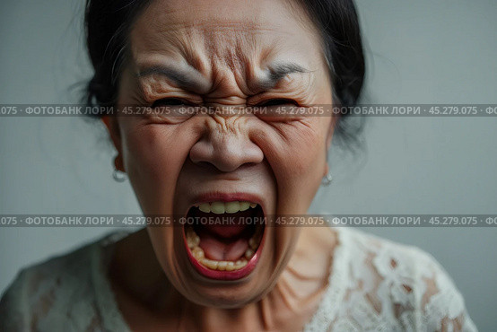asian Elder senior woman with angry, mad, depressive and furious face expression looking for fight isolated over grey dirty background. Mature female yelling with closed eyes, annoyed and frustrated. Стоковое AI-изображение, AI-художник Sergey Grishin / Фотобанк Лори