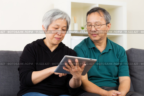 Asian old couple using tablet. Стоковое фото, фотограф Leung Cho Pan / PantherMedia / Фотобанк Лори