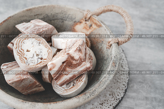 Assortment of halva. Uzbek cuisine. Halva is a sweet confectionery product made from ground sesame seeds or sunflower seeds combined with sugar and nuts. Oriental sweets. Стоковое фото, фотограф Оксана Медведева / Фотобанк Лори