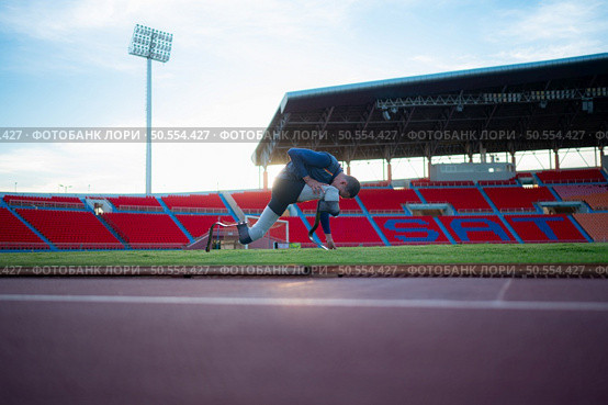 Athletes with disabilities take a break at the stadium between training sessions. Стоковое фото, агентство Ingram Publishing / Фотобанк Лори
