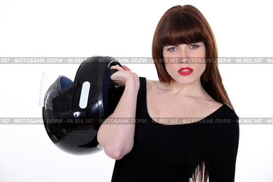 Attractive woman carrying a motorcycle helmet. Стоковое фото, агентство Ingram Publishing / Фотобанк Лори