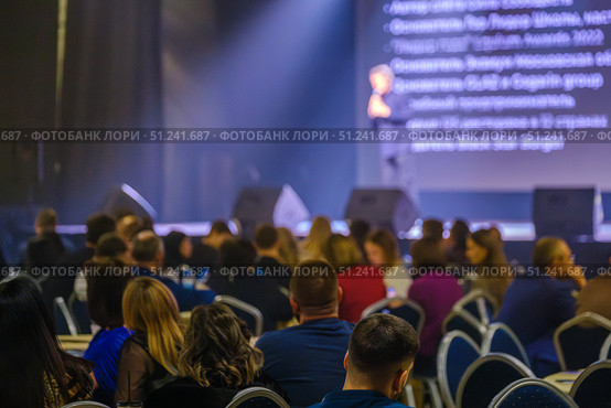 Audience listening to speaker at business conference in a dimly lit venue. Стоковое фото, фотограф Антон Гвоздиков / Фотобанк Лори