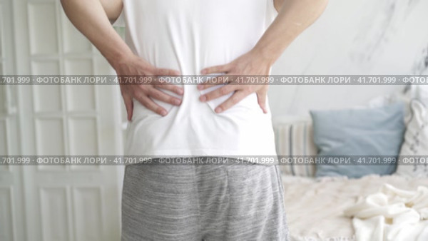 Back pain, kidney inflammation, man suffering from backache at home, health problems concept. Стоковое видео, видеограф Станислав Тарко / Фотобанк Лори