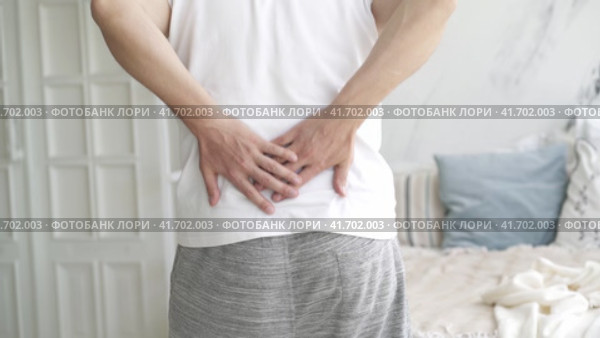Back pain, kidney inflammation, man suffering from backache at home, health problems concept. Стоковое видео, видеограф Станислав Тарко / Фотобанк Лори