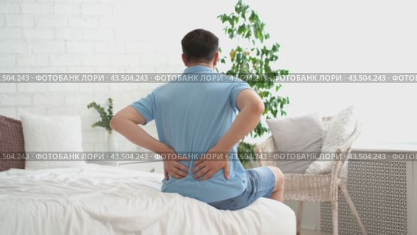 Back pain, kidney inflammation, man suffering from backache at home, health problems concept. Стоковое видео, видеограф Станислав Тарко / Фотобанк Лори