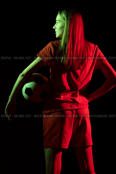back view woman holding football ball. Стоковое фото, агентство Ingram Publishing / Фотобанк Лори