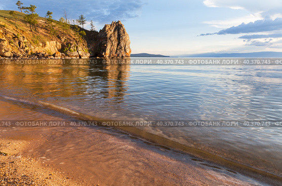 Baikal Lake on sunny summer day. Beautiful landscape of Olkhon Island with sandy beach and sheer cliffs near village of Khuzhir at sunset. Summer travel, outdoor recreation. Natural background. Стоковое фото, фотограф Виктория Катьянова / Фотобанк Лори