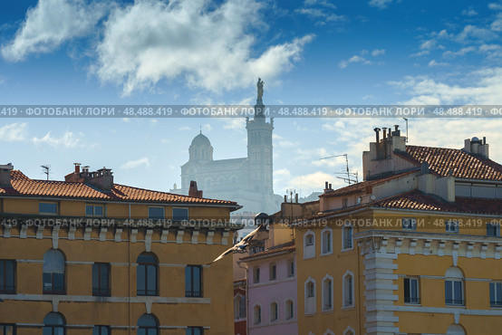 Basilique Notre-Dame de la Garde in the foggy background with red tiled roof Marseille houses (2018 год). Стоковое фото, фотограф Сергей Богомяко / Фотобанк Лори