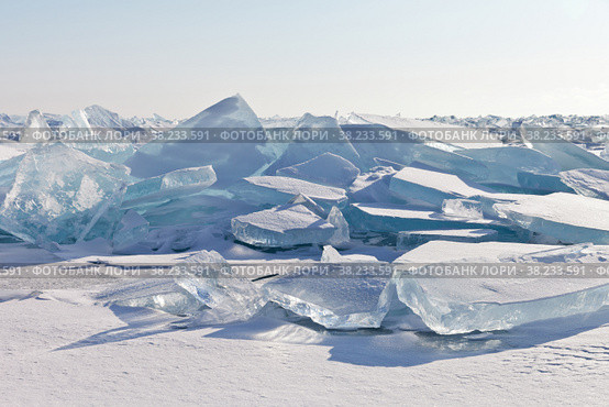Beautiful huge blocks of blue ice on a hummock field of frozen Lake Baikal on a sunny frosty day. Cold natural background. Unusual winter landscape. Стоковое фото, фотограф Виктория Катьянова / Фотобанк Лори