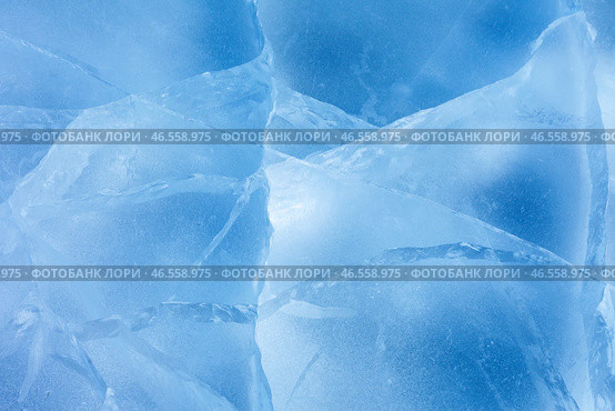 Beautiful natural ice texture of frozen Baikal Lake in cold winter day. Blue ice surface with pattern of white cracks. Nature winter background.  Mock up, copy space, flat lay, blank, close-up. Стоковое фото, фотограф Виктория Катьянова / Фотобанк Лори