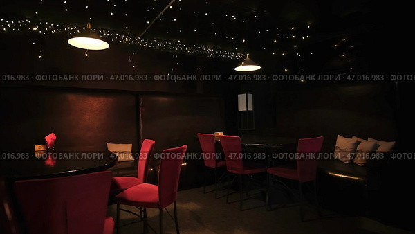 Beautiful space in nightclub with tables and garlands. Стоковое фото, фотограф David Kashakhi / Фотобанк Лори