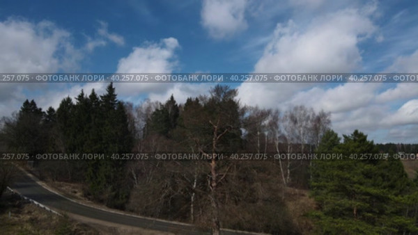 Beautiful spring landscape with road and forest. Aerial photography from a drone. Стоковое видео, видеограф Ярославский Максим / Фотобанк Лори