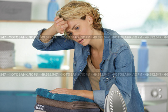 beautiful woman is tired of ironing every day. Стоковое фото, агентство Ingram Publishing / Фотобанк Лори