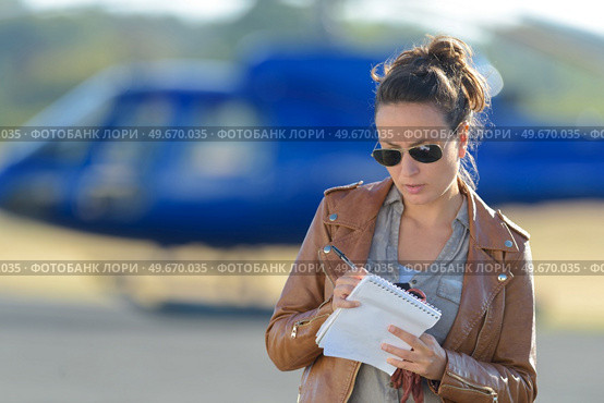 beautiful woman pilot with paperwork before flying. Стоковое фото, агентство Ingram Publishing / Фотобанк Лори