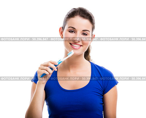 Beautiful woman with a great smile holding toothbrush, isolated over a white background. Стоковое фото, агентство Ingram Publishing / Фотобанк Лори