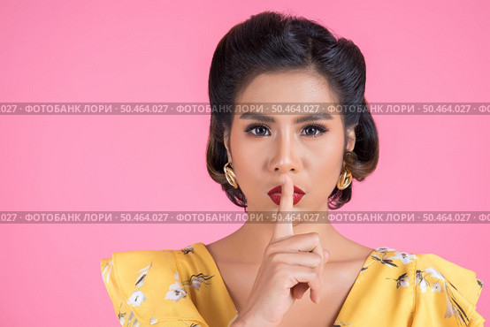Beauty asian woman red lips and finger showing hush silence sign. Стоковое фото, агентство Ingram Publishing / Фотобанк Лори