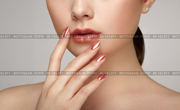 Beauty brunette woman with perfect makeup. Glamour girl. Red lips and nails. Skin care foundation. Beauty girls face isolated on light background. Fashion photo. Стоковое фото, агентство Ingram Publishing / Фотобанк Лори