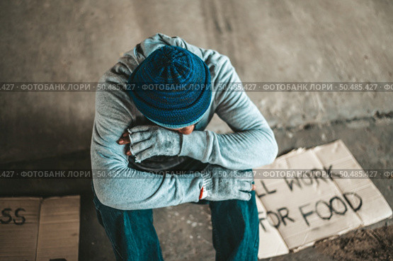 Begging under the bridge with the message will work for food. Стоковое фото, агентство Ingram Publishing / Фотобанк Лори