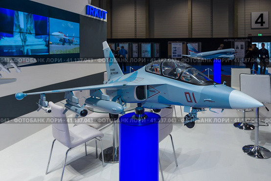 BERLIN, GERMANY - JUNE 01, 2016: The stand of Unated Aircraft Corporation (Russia). Model of Russian subsonic two-seat advanced jet trainer Yakovlev Yak-130. Exhibition ILA Berlin Air Show 2016. Редакционное фото, фотограф Sergey Kohl / Фотобанк Лори