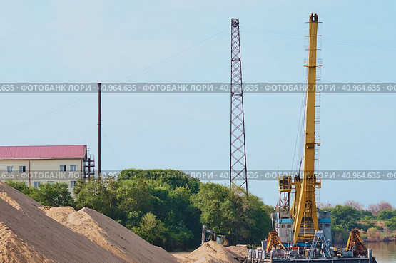 Big pile of sand. Building with a chimney in the background. Summer morning. Deepening the bottom of the river. Стоковое фото, фотограф Алексей Игнатов / Фотобанк Лори