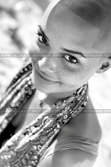 Black and white portrait of a woman with a shaved head, showcasing a bold and unique hairstyle. Стоковое AI-изображение, AI-художник Данила Большаков / Фотобанк Лори
