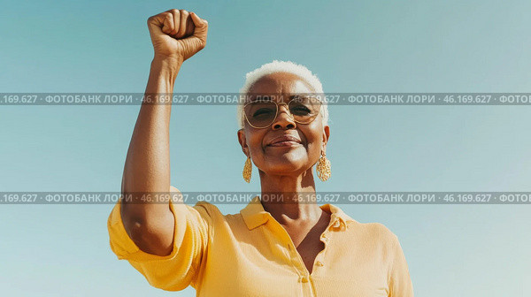 Black mature woman outdoors with raised fist of empowerment, strength and women solidarity, International Womens Day, Black History Month concept. Стоковое AI-изображение, AI-художник Анастасия Золотницкая / Фотобанк Лори