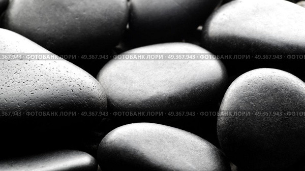 Black pebbles background backlite. Black pebbles background. Стоковое фото, агентство Ingram Publishing / Фотобанк Лори