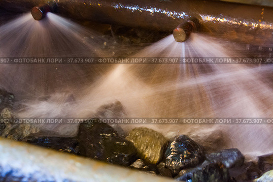 Blurred photo background. Water jets and ore rocks. Washing gold ore on concentrating plant. Khromtau, Mechel, Kazakhstan. Стоковое фото, фотограф Alexey Rezvykh / Фотобанк Лори