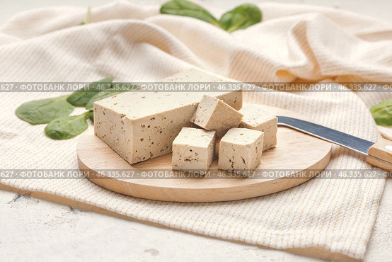 Board with tasty tofu cheese on table. Стоковое фото, фотограф Pixel_shot / Фотобанк Лори
