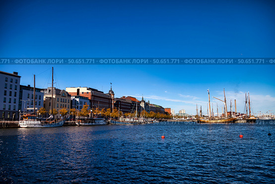 Boats Docked at Katajanokka Harbor With Buildings in Helsinki, Finland, on a Bright Day (2024 год). Редакционное фото, фотограф Aleksandr Golubev / Фотобанк Лори