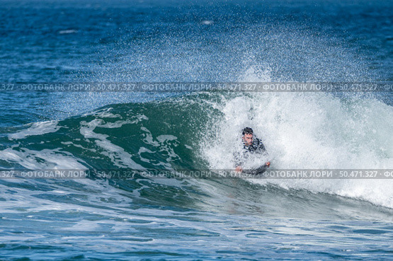 Bodyboarder surfing ocean wave on a sunny winter day. Стоковое фото, агентство Ingram Publishing / Фотобанк Лори