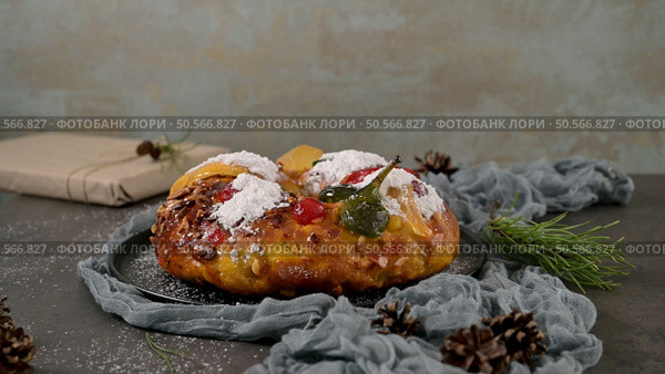 Bolo Rei or Kings Cake is a traditional Xmas cake with fruits raisins nut and icing on kitcthen countertop. Is made for Christmas, Carnavale or Mardi Gras. Стоковое фото, агентство Ingram Publishing / Фотобанк Лори
