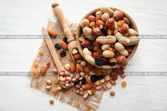 Bowl with various tasty nuts and dried fruits on wooden table. Стоковое фото, фотограф Pixel_shot / Фотобанк Лори