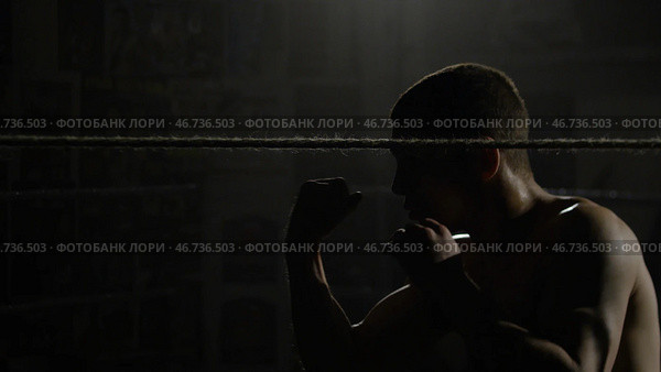 Boxer doing exercises with a rope for slope, dives and punches. Стоковое фото, фотограф David Kashakhi / Фотобанк Лори