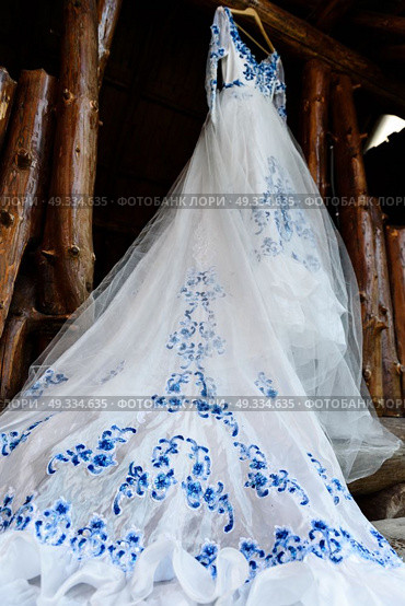 bridesmaid dress in the style of Gzhel hanging on a wooden beam in the input aperture of the house. Стоковое фото, агентство Ingram Publishing / Фотобанк Лори