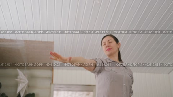 Brunette woman dance, have fun at home listens song, moves to music, feels overjoyed, celebrate good news, relish carefree life looks happy. Young adult female twirls, grooves. Lady dancing in kitchen. Стоковое видео, видеограф Марина Демидюк / Фотобанк Лори
