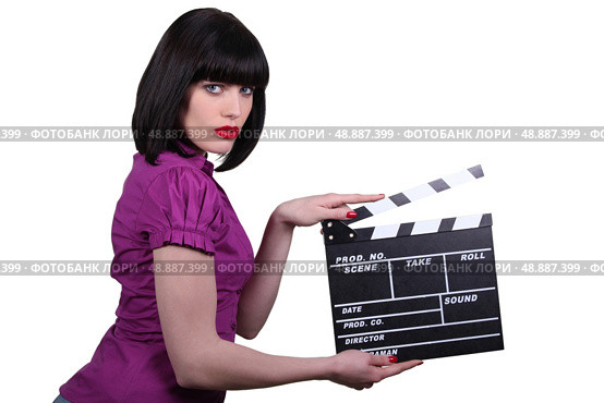 brunette woman with a cinema clap. Стоковое фото, агентство Ingram Publishing / Фотобанк Лори