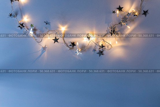 burning garland with spangles blue table. Стоковое фото, агентство Ingram Publishing / Фотобанк Лори