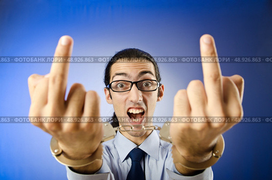 Businessman handcuffed in studio shooting. Стоковое фото, агентство Ingram Publishing / Фотобанк Лори