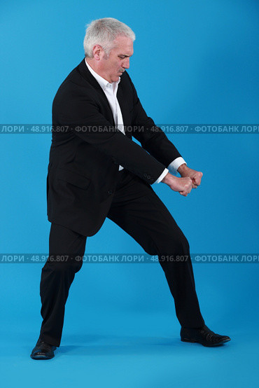 Businessman performing pull gesture. Стоковое фото, агентство Ingram Publishing / Фотобанк Лори