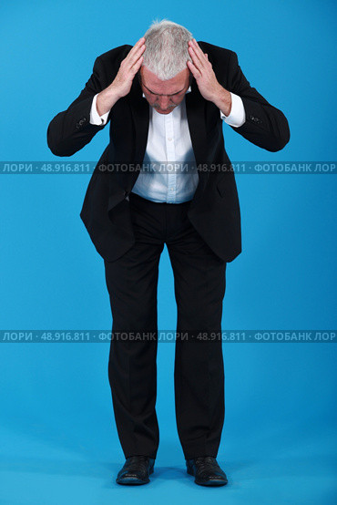 Businessman staring at the ground. Стоковое фото, агентство Ingram Publishing / Фотобанк Лори