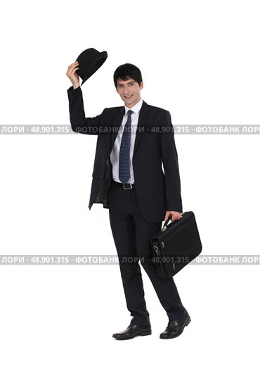 Businessman tipping his bowler hat. Стоковое фото, агентство Ingram Publishing / Фотобанк Лори