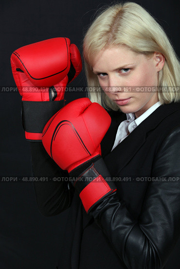 Businesswoman holding boxing gloves. Стоковое фото, агентство Ingram Publishing / Фотобанк Лори