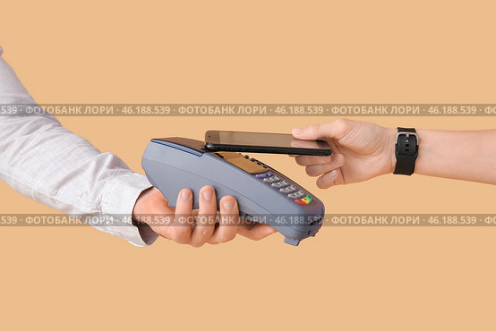 Buyer paying for purchase via terminal on color background. Стоковое фото, фотограф Pixel_shot / Фотобанк Лори