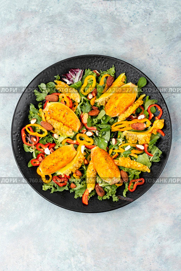 Cactus salad with sliced opuntia or prickly pear, peppers, almonds and fresh herbs, served in plate. Flat lay. Fresh vegan cactus salad on a plate. Стоковое фото, агентство Ingram Publishing / Фотобанк Лори