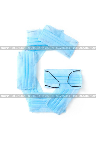 Capital letter G handmade from medical antibacterial protective blue face masks on a white background, copy space. Creative alphabet for making up new words.. Letter G made from protective medical masks on a white background. Стоковое фото, агентство Ingram Publishing / Фотобанк Лори