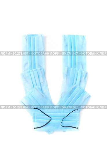 Capital letter U handmade from medical antibacterial protective blue face masks on a white background, copy space. Creative alphabet for making up new words.. Letter U made from protective medical masks on a white background. Стоковое фото, агентство Ingram Publishing / Фотобанк Лори